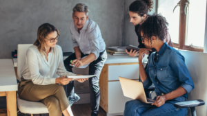 A small group of business owners reviewing a purchase of new equipment