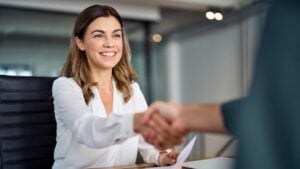 A business owner shaking hands with a financial partner