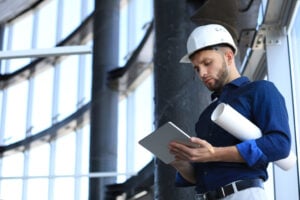 Shot of a engineer using a digital tablet on a construction site. This software help me to keep track of everything