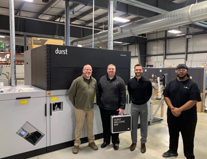 Impact Label team standing in front of new Durst Tau printing press during equipment installation